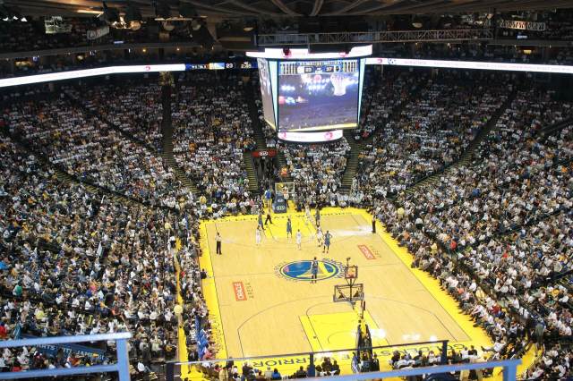 Photo of the Golden State Warriors playing in a crowded stadium Photo of the Golden State Warriors playing in a crowded stadium