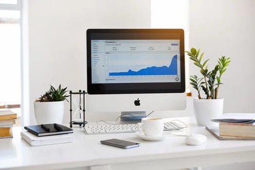 Computer screen displaying a graph that shows progress over time Computer screen displaying a graph that shows progress over time