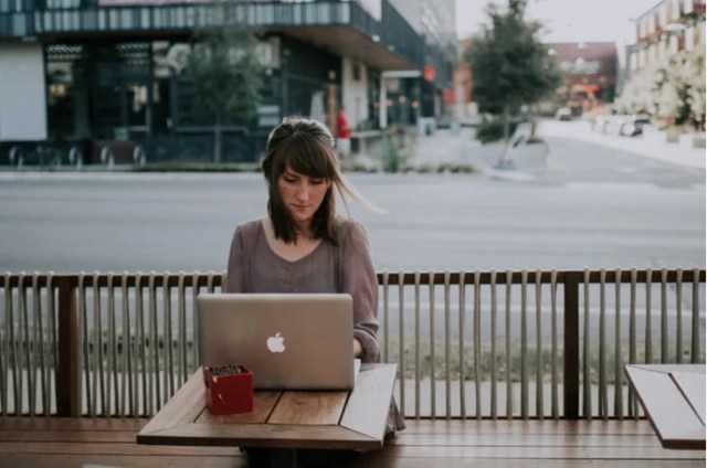 Woman using a laptop outside Woman using a laptop outside
