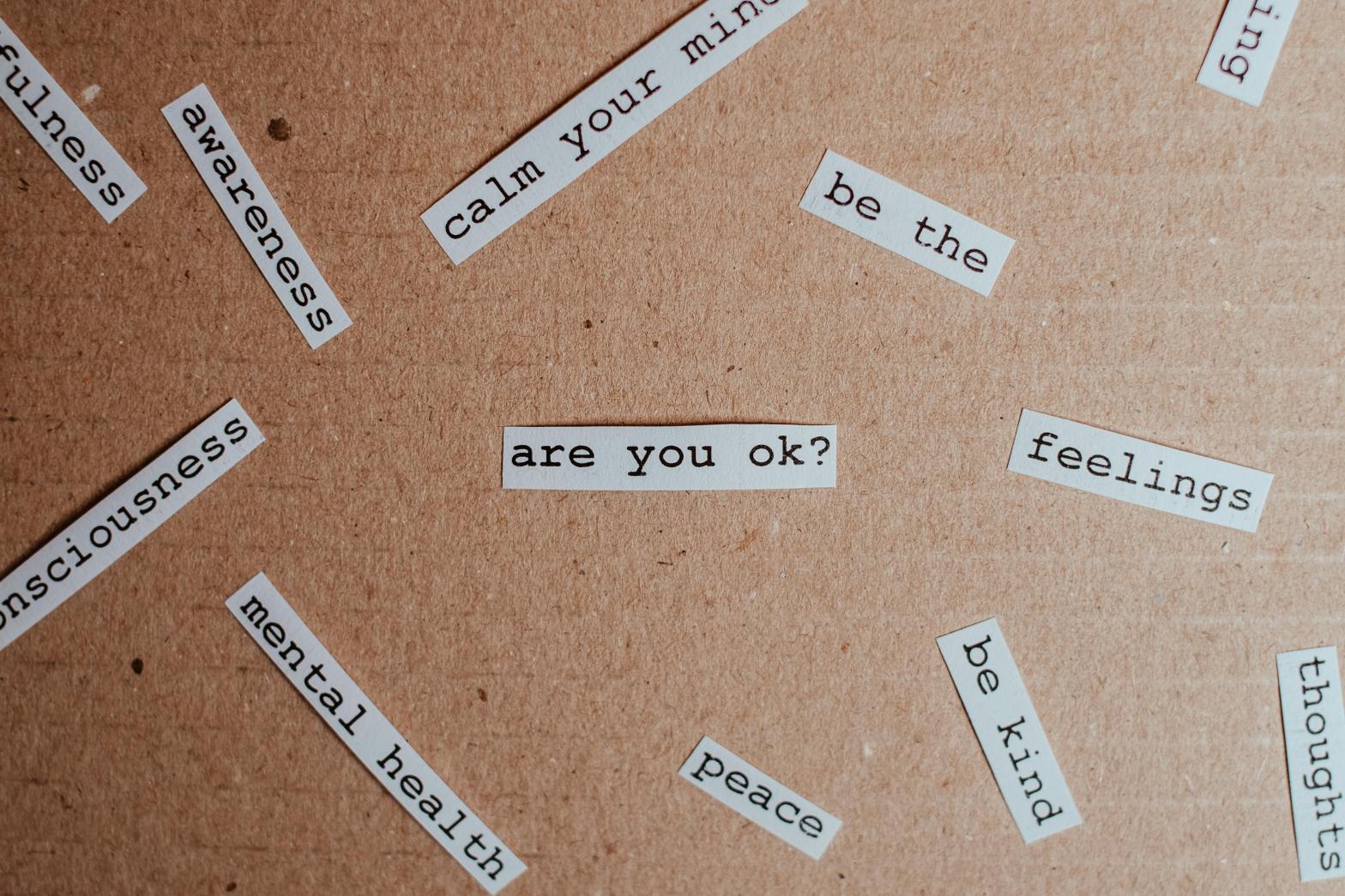 Collage of mental health phrases on bulletin board
