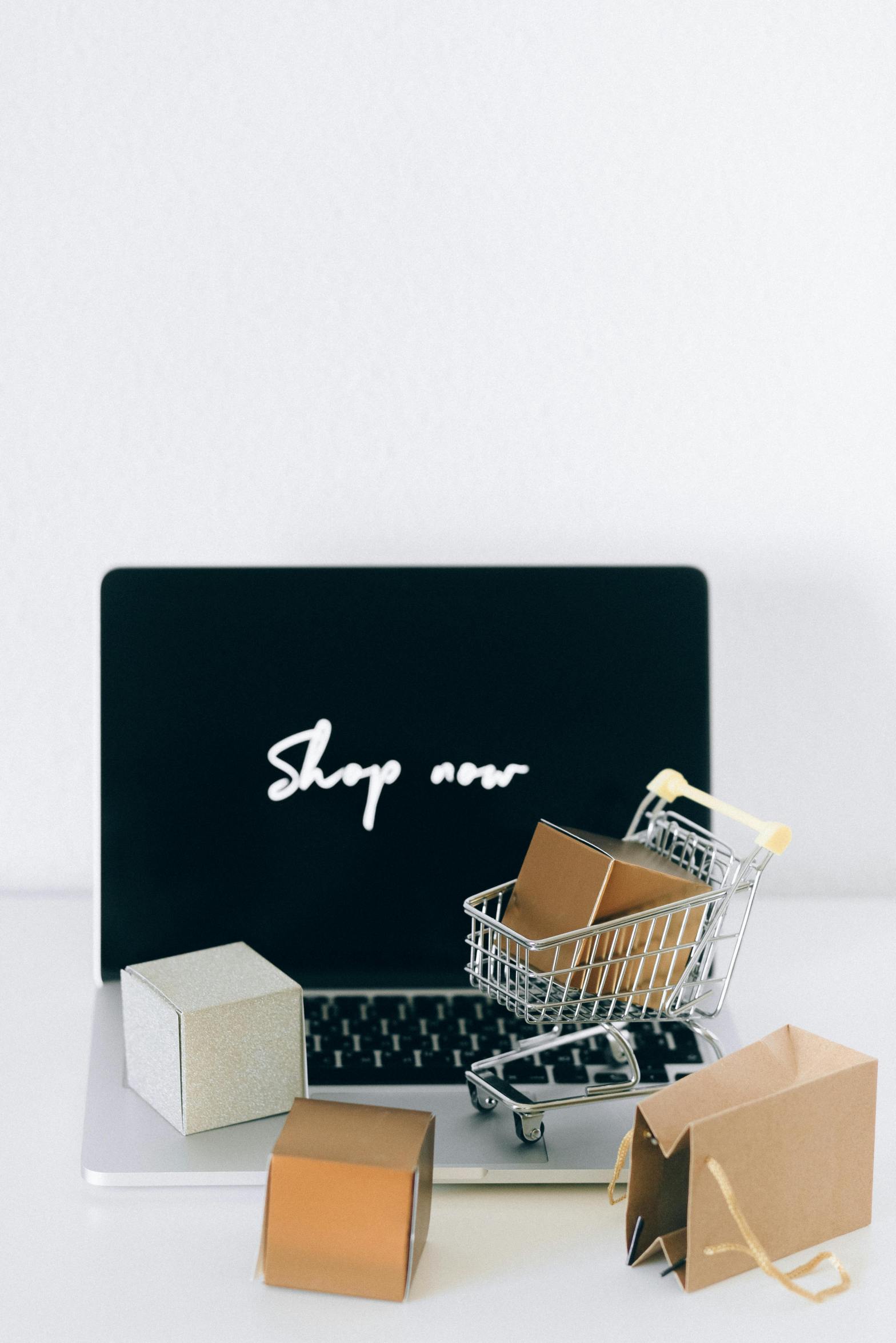 Shop now letters in white on black screen with mini shopping cart and packages
